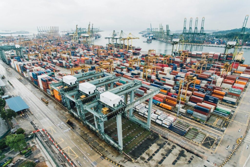 Aerial view of a container terminal with rail links and stacked freight containers
