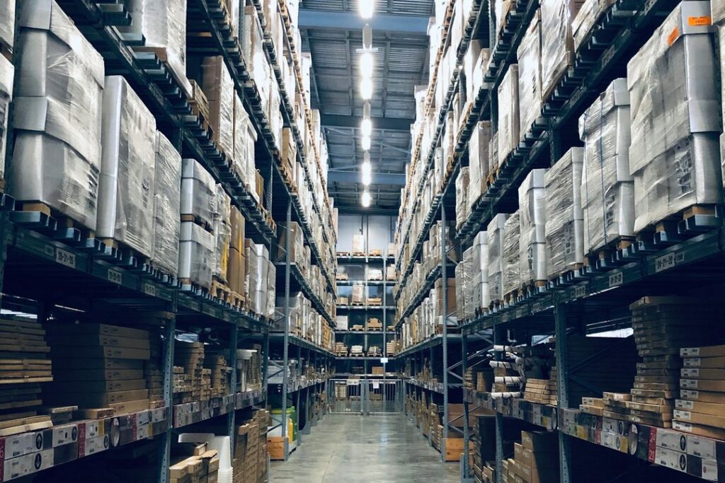 Long aisle of racked pallets inside a modern distribution warehouse