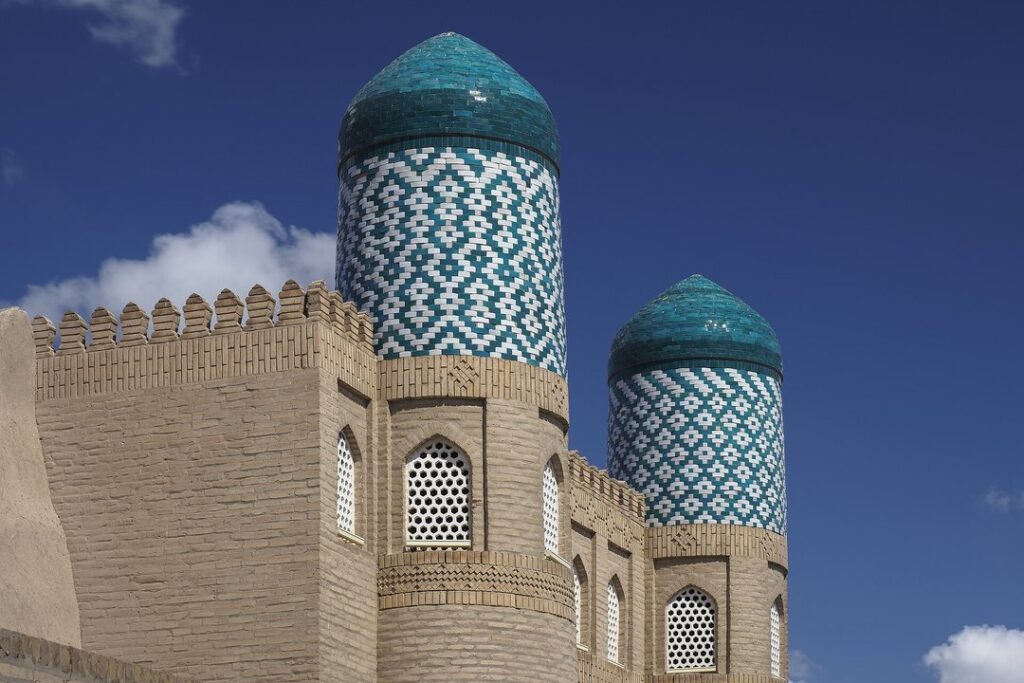 Turquoise tiled minaret and towers of the walled old city of Khiva, Uzbekistan