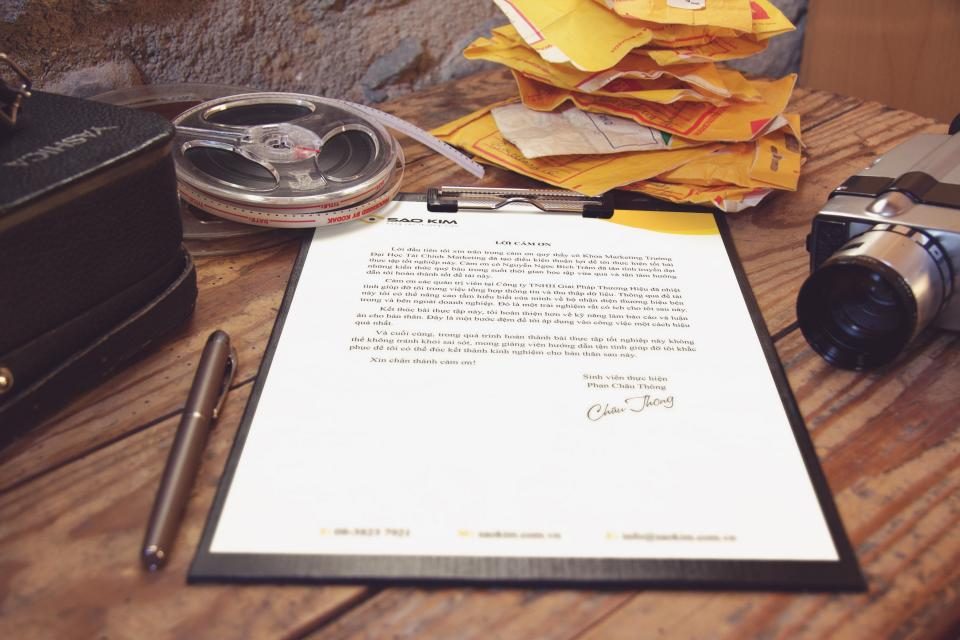 Signed formal agreement document resting on a desk beside a fountain pen