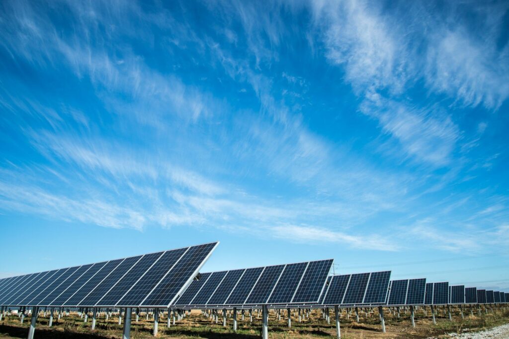 Rows of solar panels generating clean electricity under a bright sky